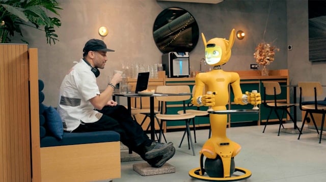 Man and robot interacting in a cafe for building trust with website visitors blog